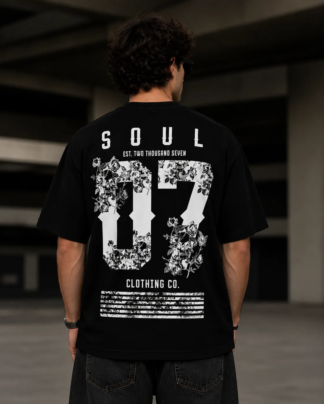 Black oversized T-shirt with SOUL 07 floral back graphic worn by a male model