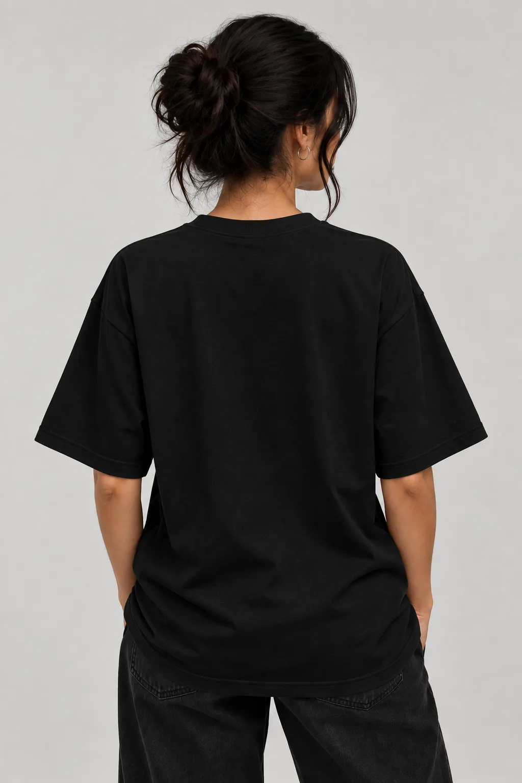 Alt text  Black and white oversized T-shirts featuring a playful cat wearing a cap and headphones with dumbbells on the back.