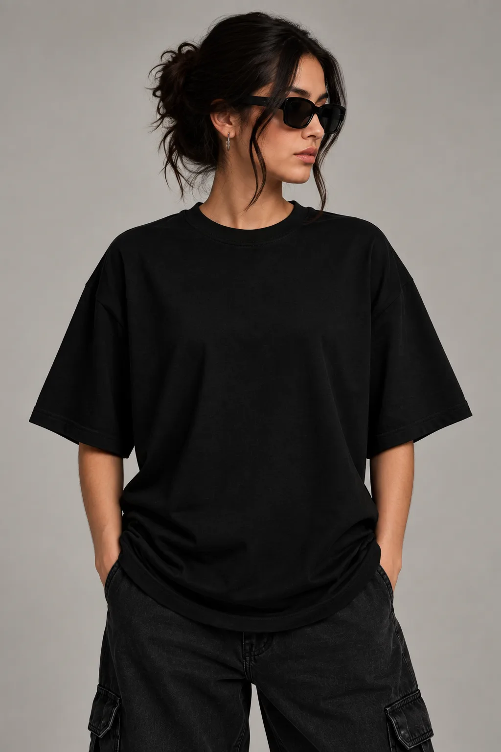 Black and white oversized T-shirts featuring a dark winged guardian figure with a crown-like halo and distressed ink-style artwork.