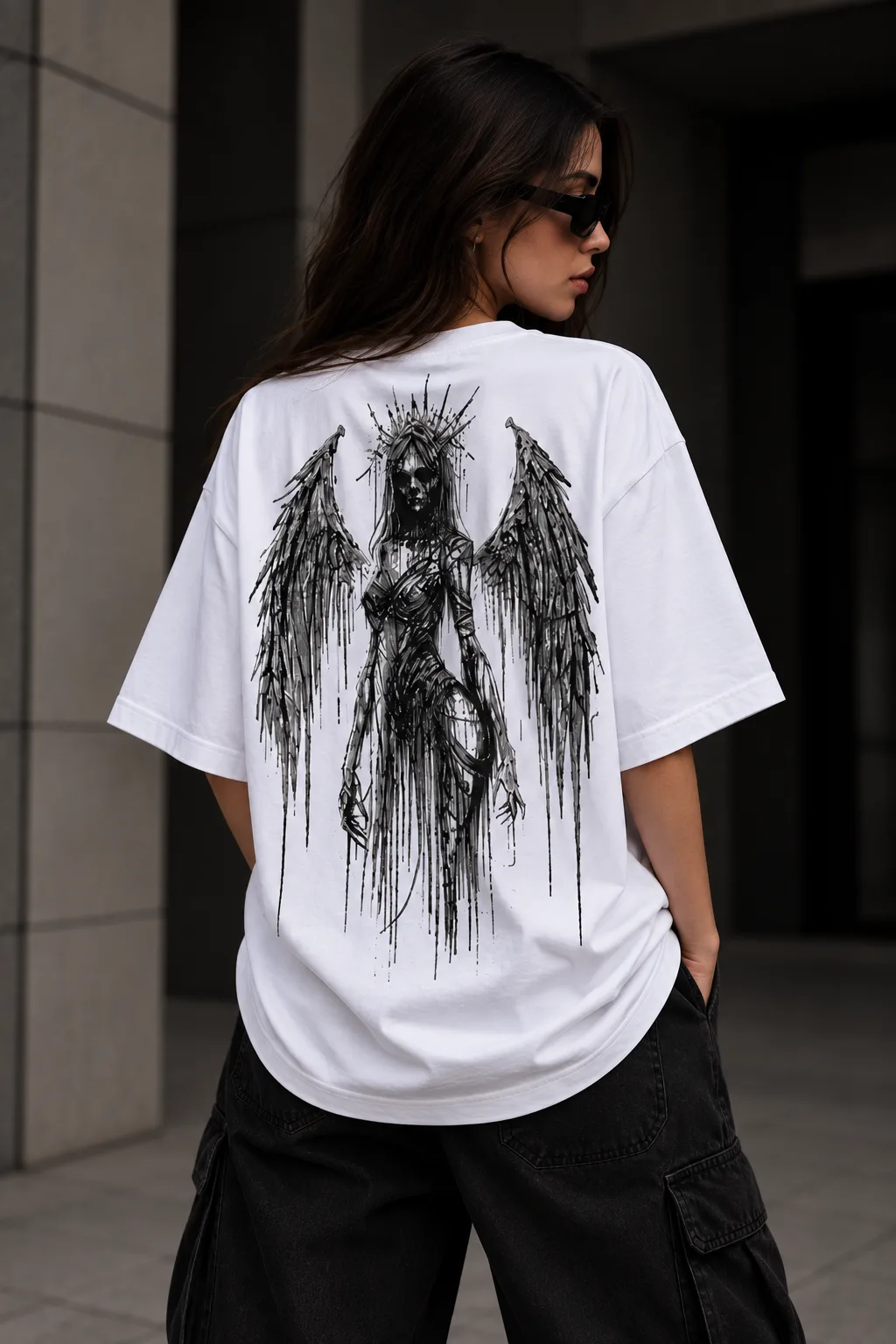 Black and white oversized T-shirts featuring a dark winged guardian figure with a crown-like halo and distressed ink-style artwork.