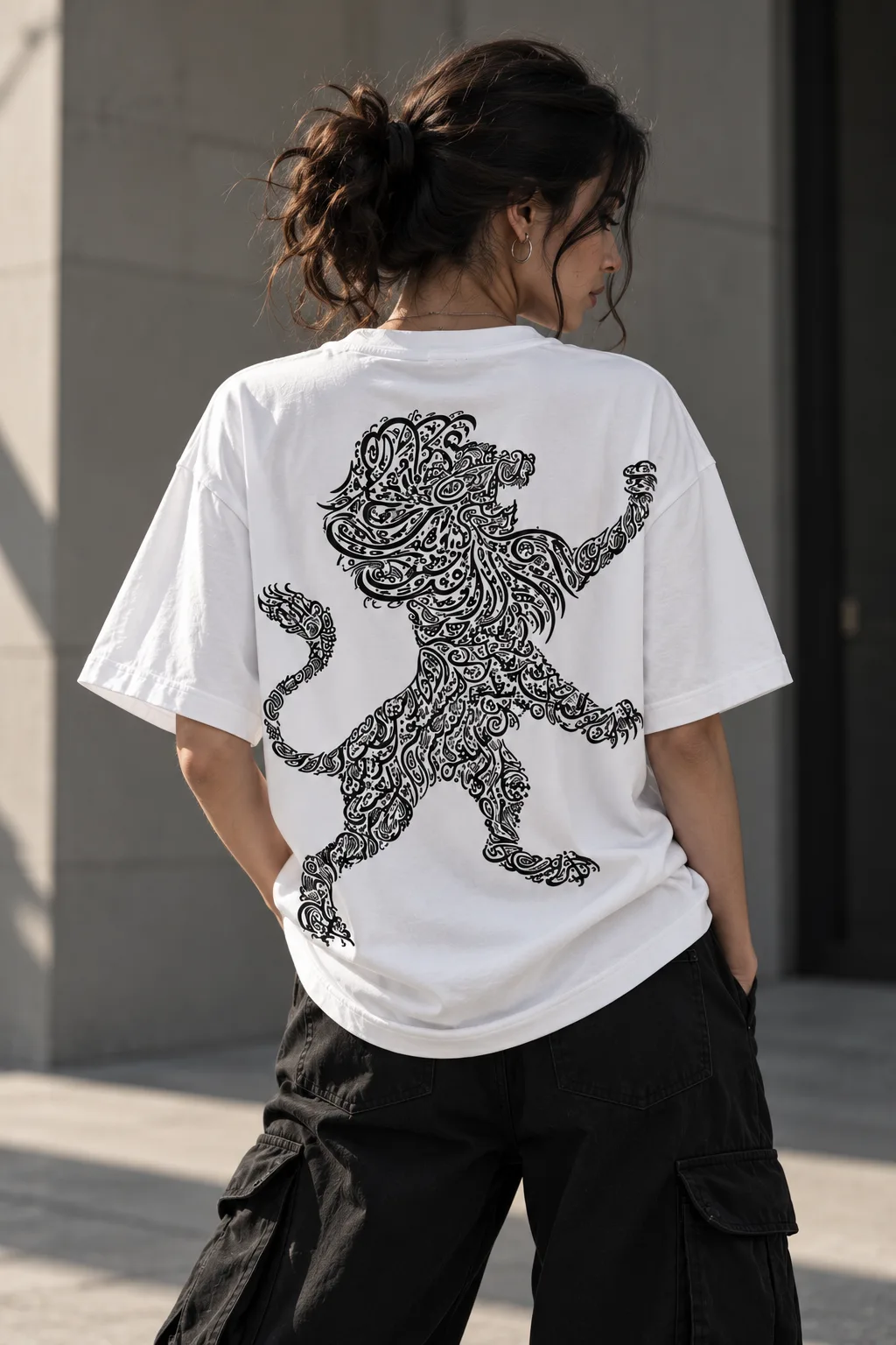 Black and white oversized T-shirts featuring a lion shaped from intricate Arabic calligraphy, blending cultural expression with modern streetwear.