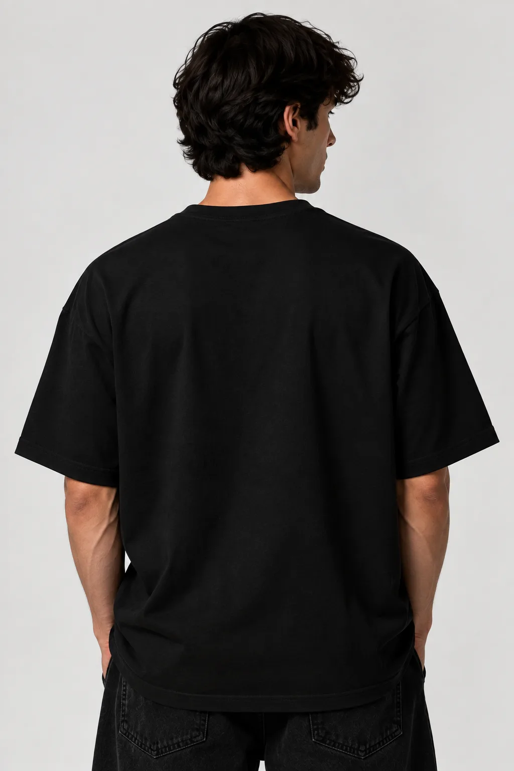 Black and white oversized T-shirt featuring a cosmic human figure surrounded by red energy trails and stars, with “YUJIN” and “BECOME ONE WITH THE UNIVERSE” across the front.