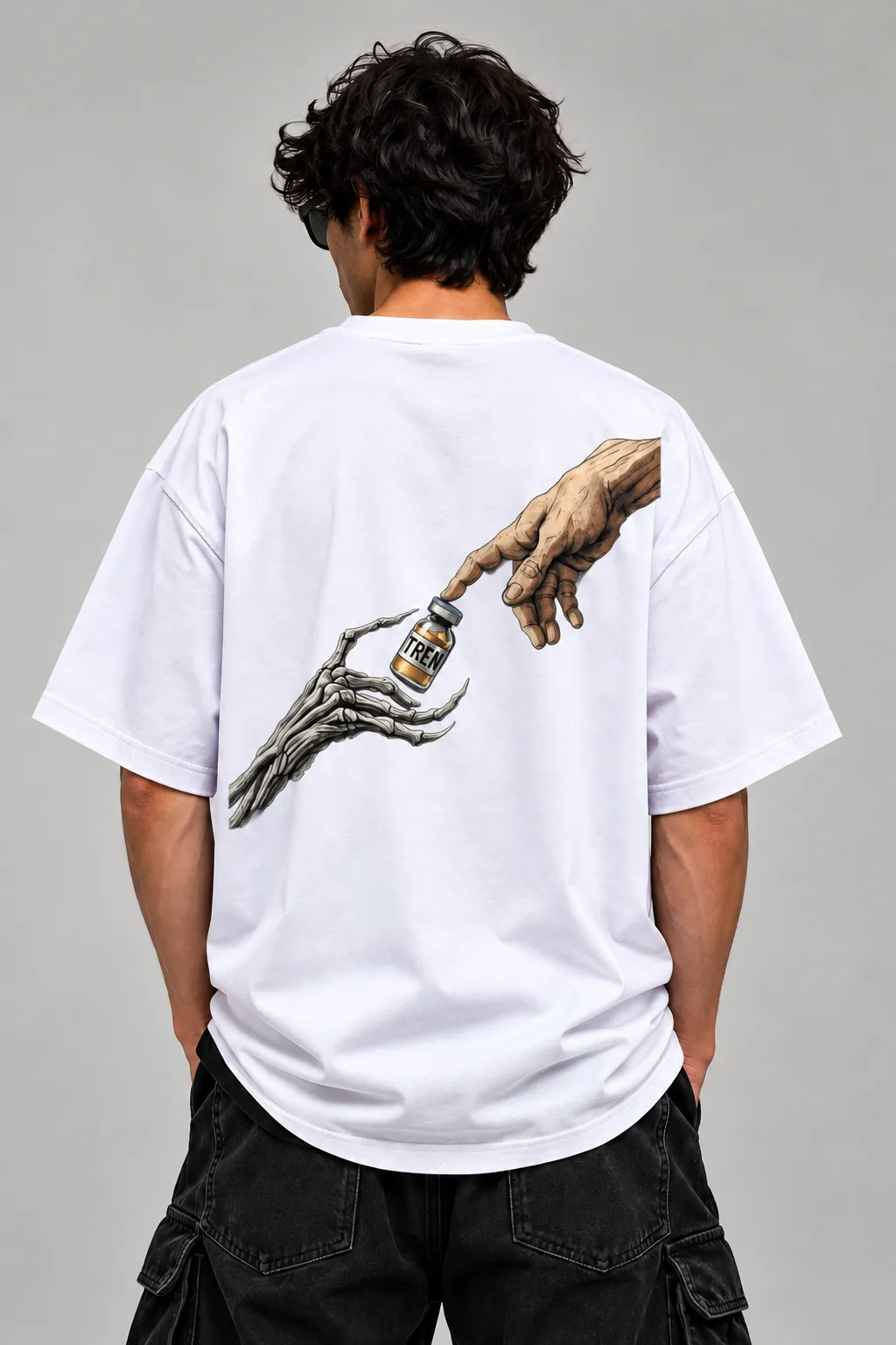 Oversized black and white streetwear T-shirts featuring a human hand reaching toward a skeletal hand holding a vial labeled “TREN,” printed across the back.