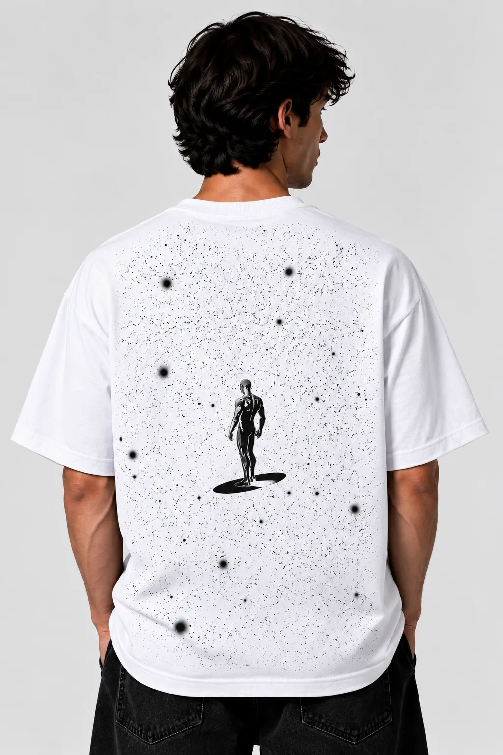 White oversized T-shirt worn by a male model, featuring a black starfield design with a human figure on the back.